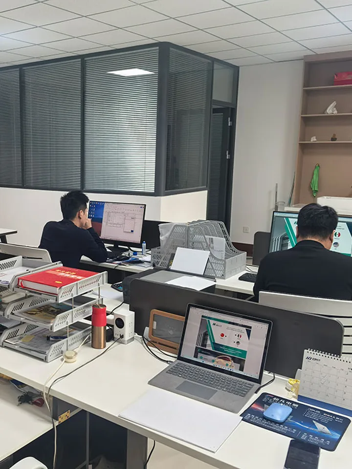 WIT team at their desks in the China office, working out prices